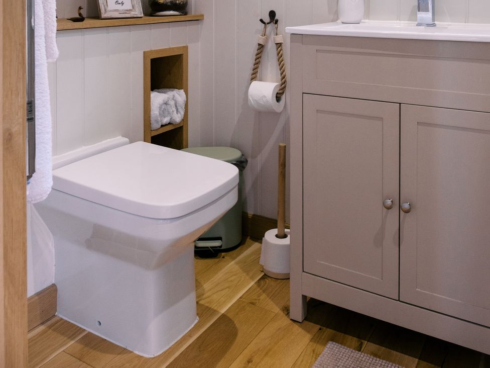 A bathroom with a toilet and sink at Herbie's Shepherds Hut at Shepherds Lodge Retreat and Wellness Bottesford near Redmile and Vale of Belvoir