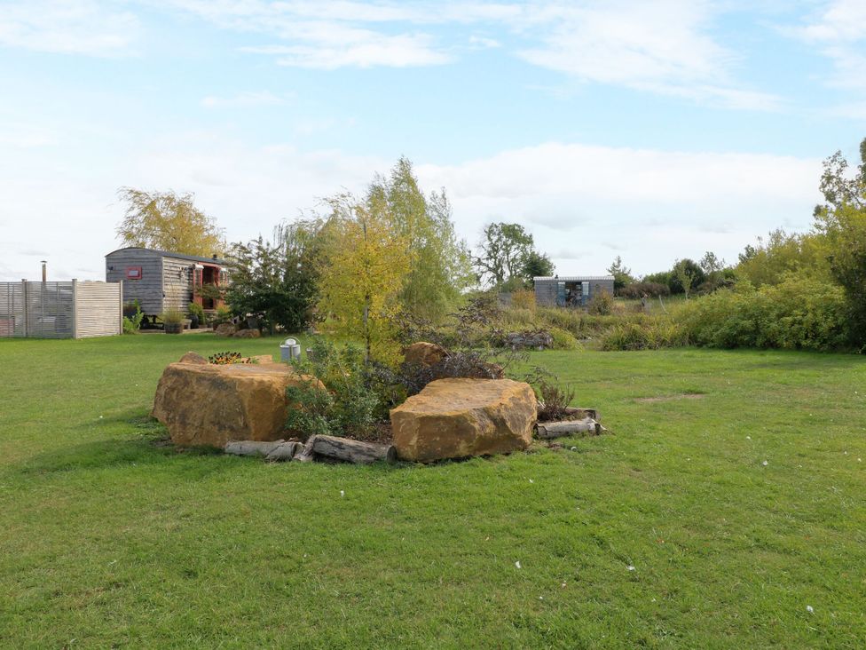 An outdoor space with stones and trees at Poppie's Shepherds Hut at Shepherds Lodge Retreat and Wellness Bottesford near Redmile and Vale of Belvoir
