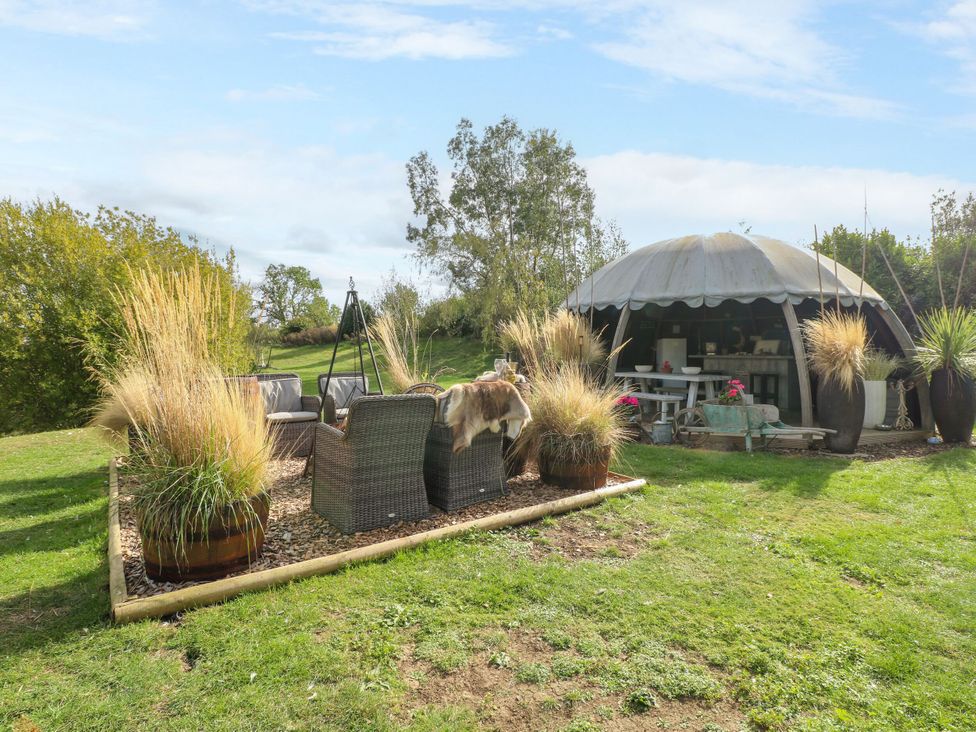 An outdoor seating area with a shed at Poppie's Shepherds Hut at Shepherds Lodge Retreat and Wellness Bottesford near Redmile and Vale of Belvoir