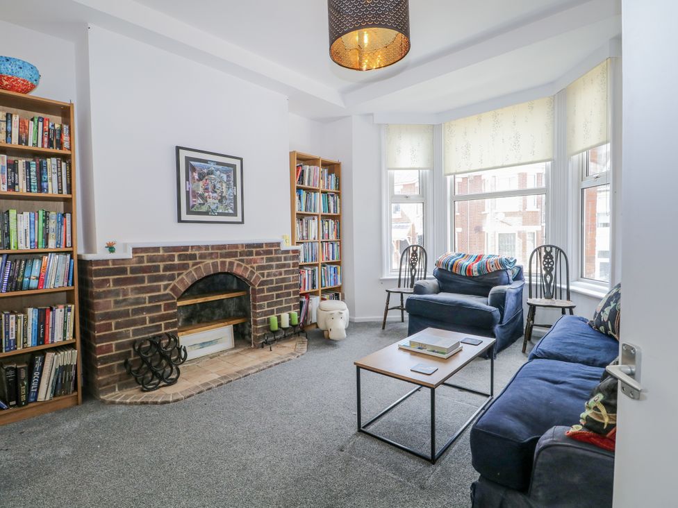 A living room with a bookshelf and sofa at 108 Emmanuel Road Hastings
