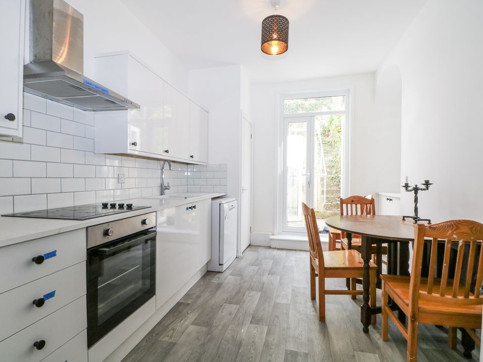 A kitchen with cabinets, stove and dining area at 108 Emmanuel Road Hastings