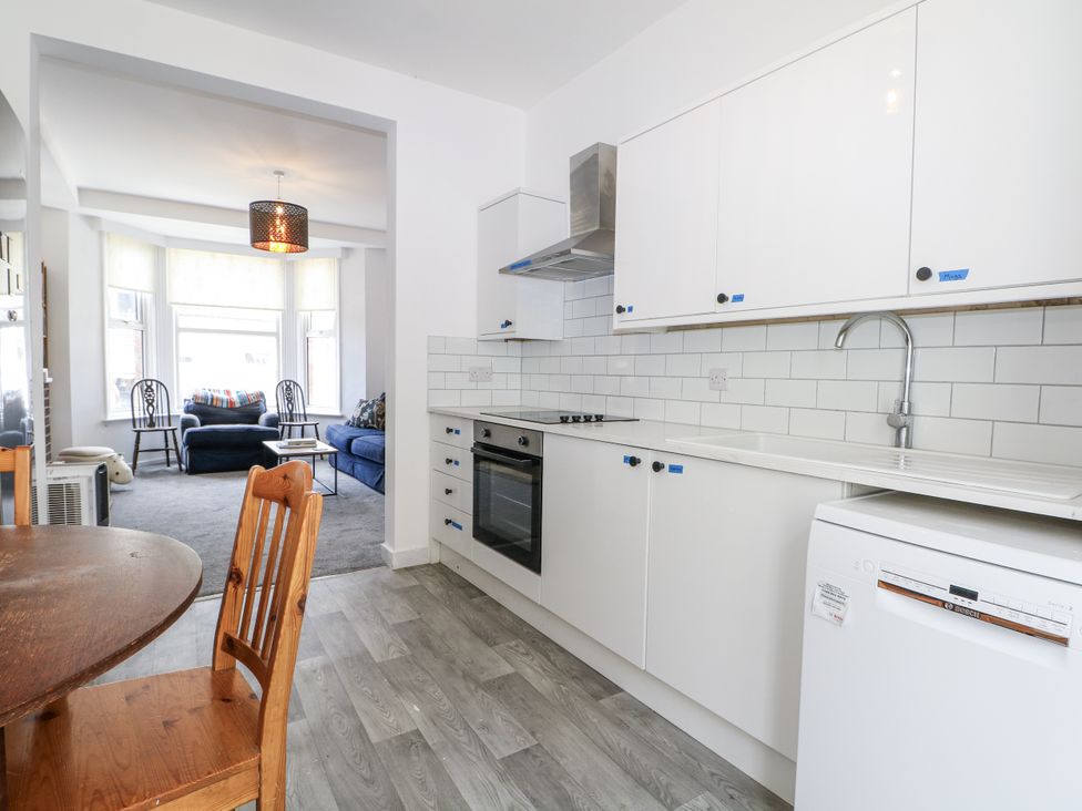 A kitchen with a dining table and chairs at 108 Emmanuel Road in Hastings