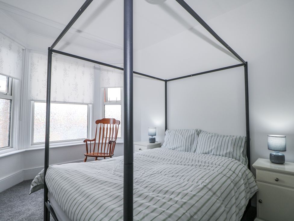 A bedroom with a bed and rocking chair at 108 Emmanuel Road Hastings