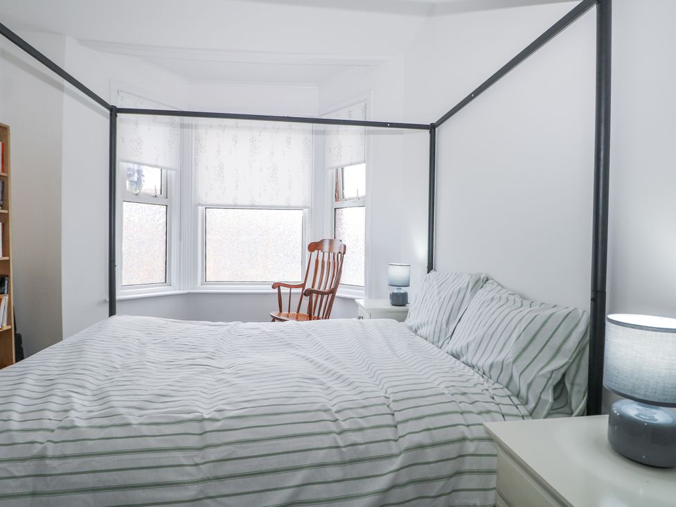 A bedroom with a bed and rocking chair at 108 Emmanuel Road Hastings