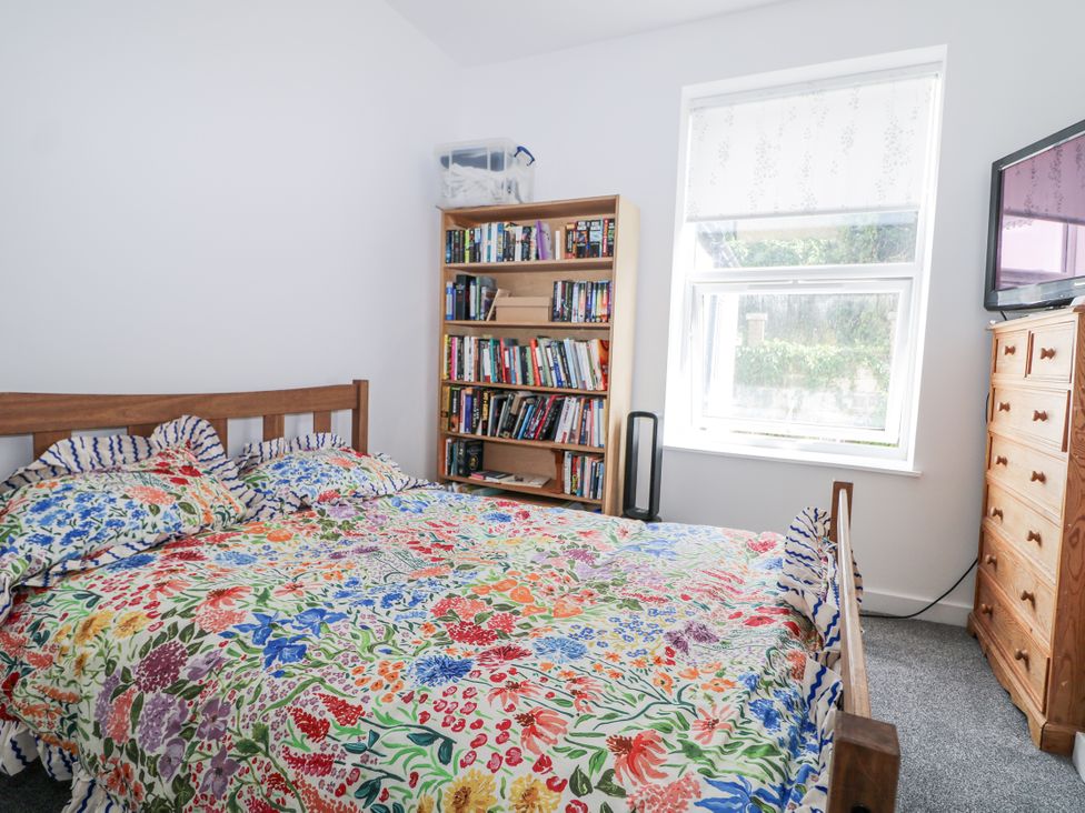 A bedroom with a bed and a bookshelf at 108 Emmanuel Road in Hastings