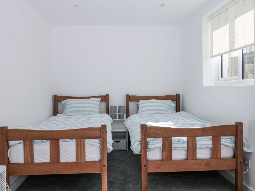 A bedroom with two beds and a nightstand at 108 Emmanuel Road in Hastings