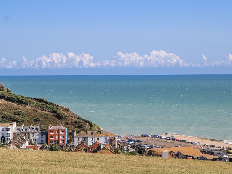 A coastal view with buildings and cars by the beach at 108 Emmanuel Road Hastings