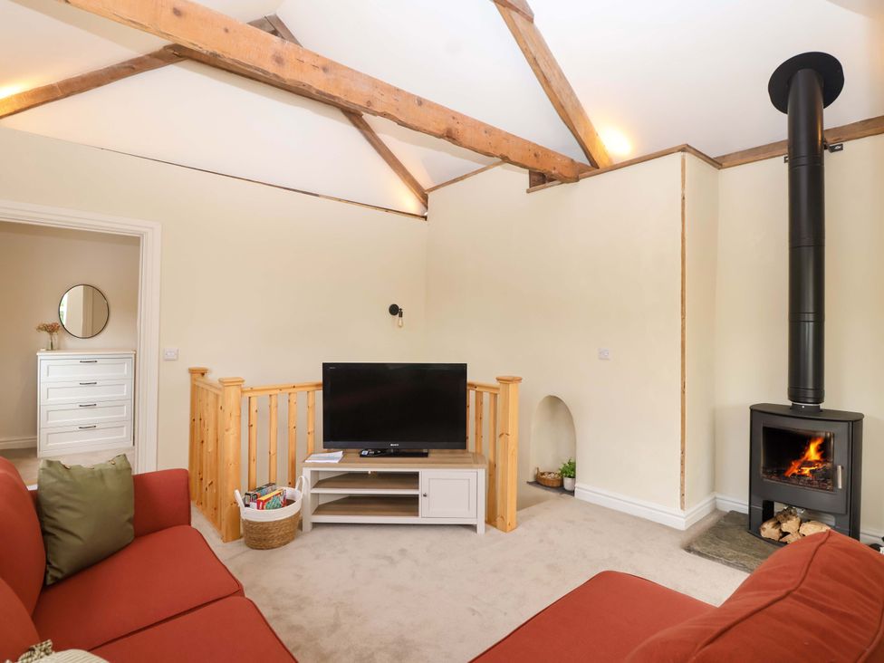 A living room with a sofa and television at Walnut Major in Kingsbridge