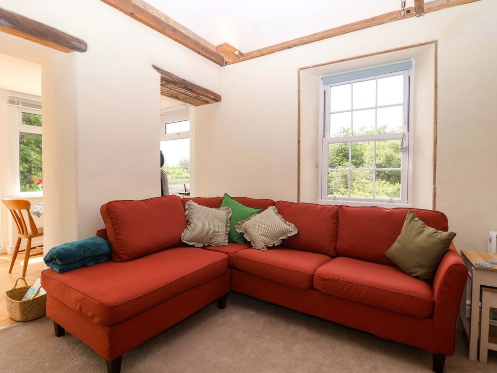 A living room with a sofa and cushions at Walnut Major in Kingsbridge