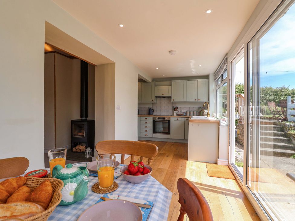 A kitchen with dining table and breakfast items at Walnut Major in Kingsbridge