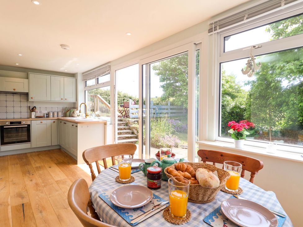 A kitchen with a table set for breakfast at Walnut Major in Kingsbridge
