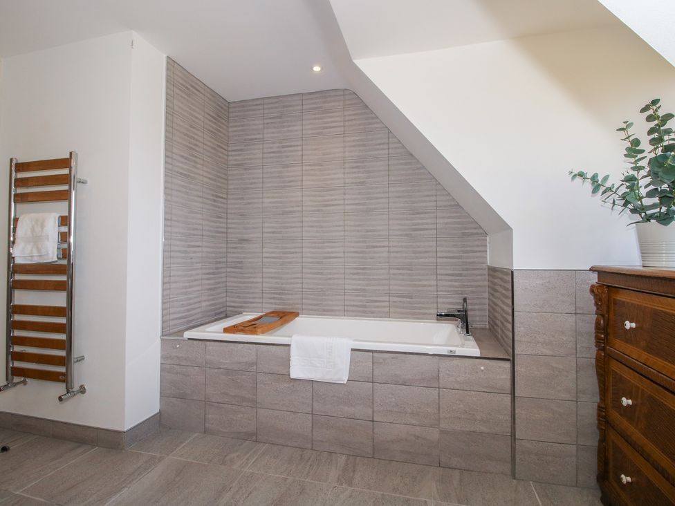 A bathroom with a bathtub and towel warmer at White House in Montgomery