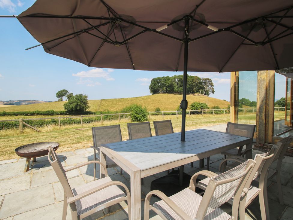 An outdoor dining area with a table and chairs at White House in Montgomery