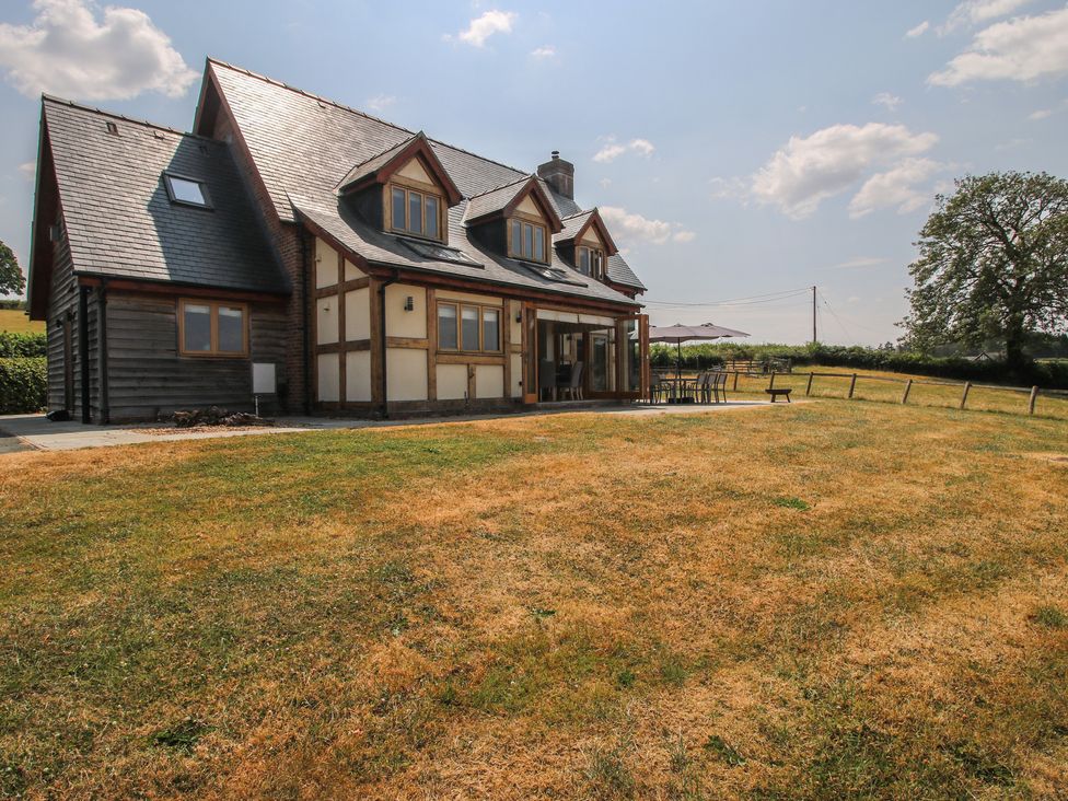 A house with a patio and surrounding grass at White House in Montgomery