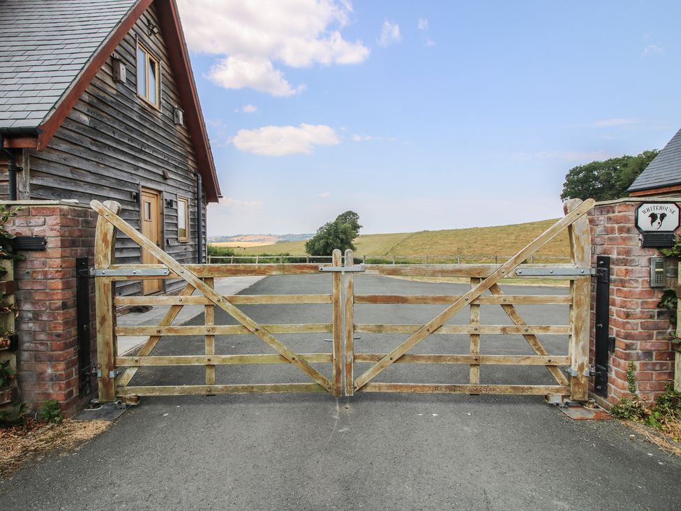A wooden gate and driveway in front of a house at White House in Montgomery