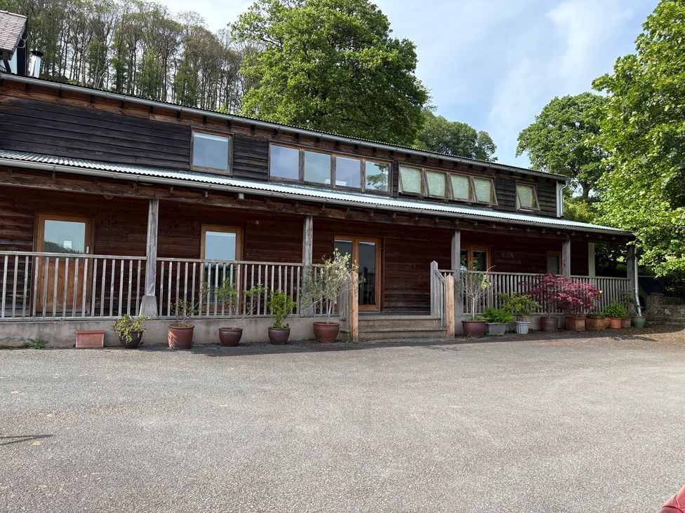 A wooden house with plants and steps at Cottage 1 in Presteigne