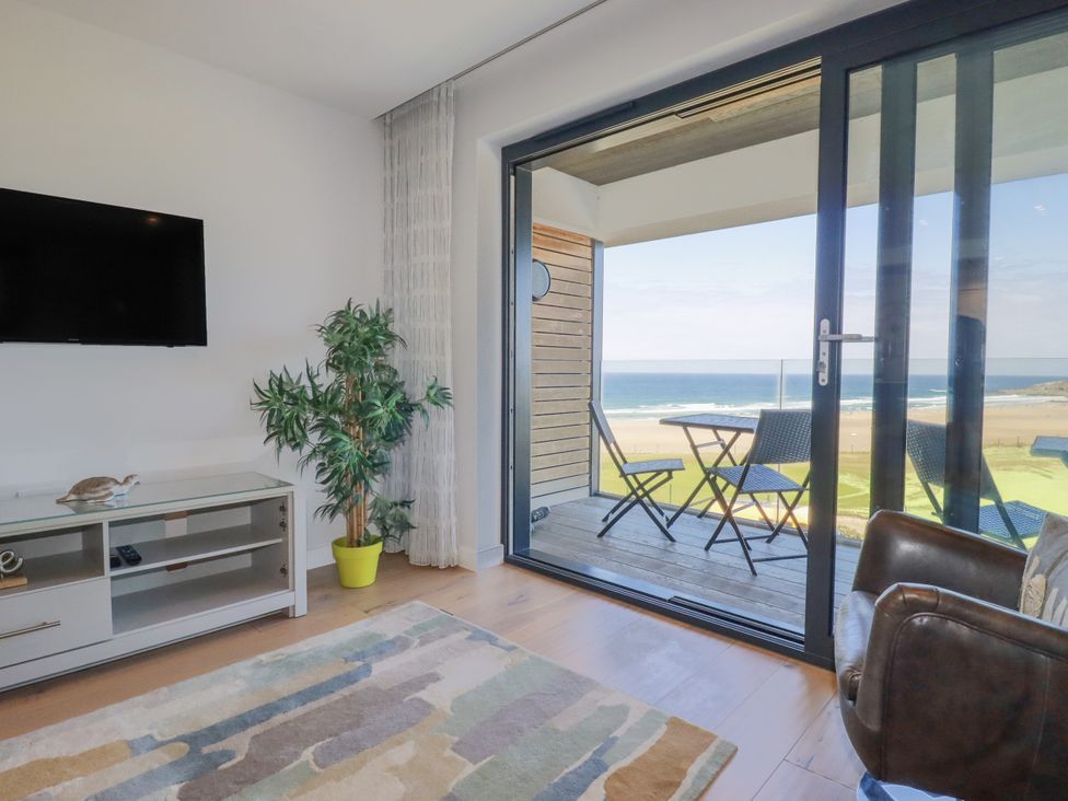 A living room with a television and couch at Apartment 8 