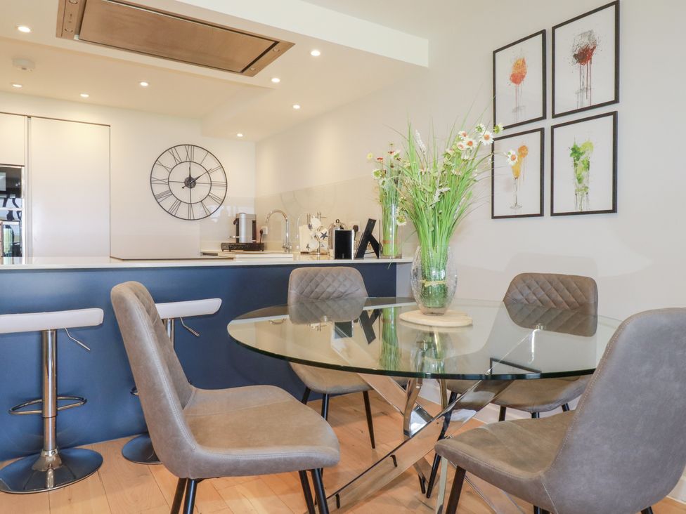 A dining area with a glass table and chairs at Apartment 8 