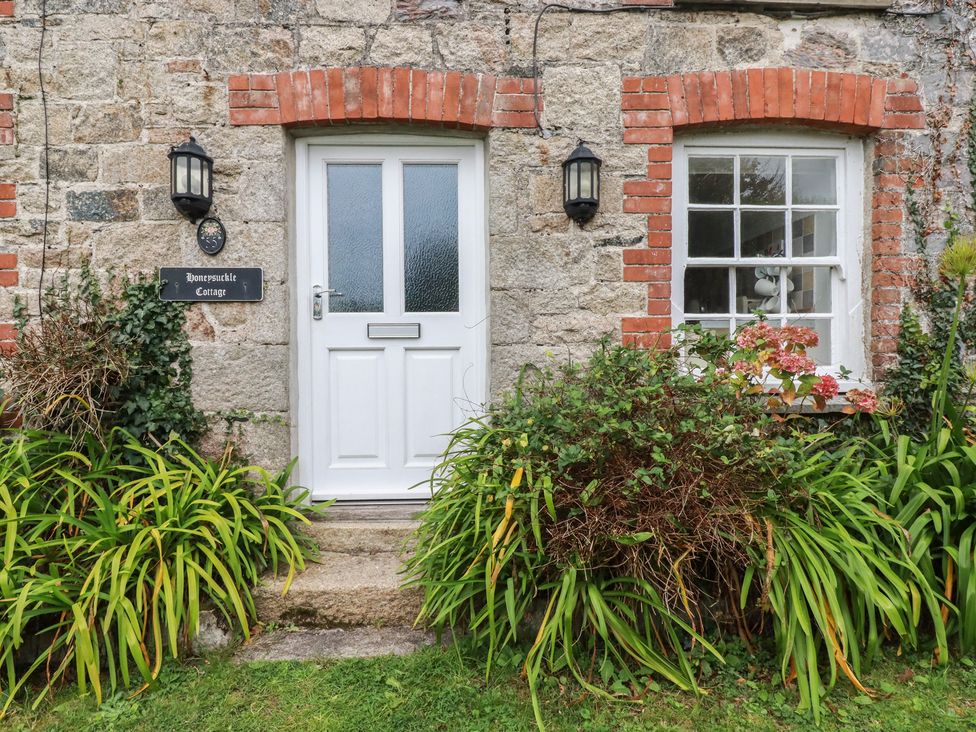 A front entrance with door and plants at Honeysuckle Cottage in Charlestown