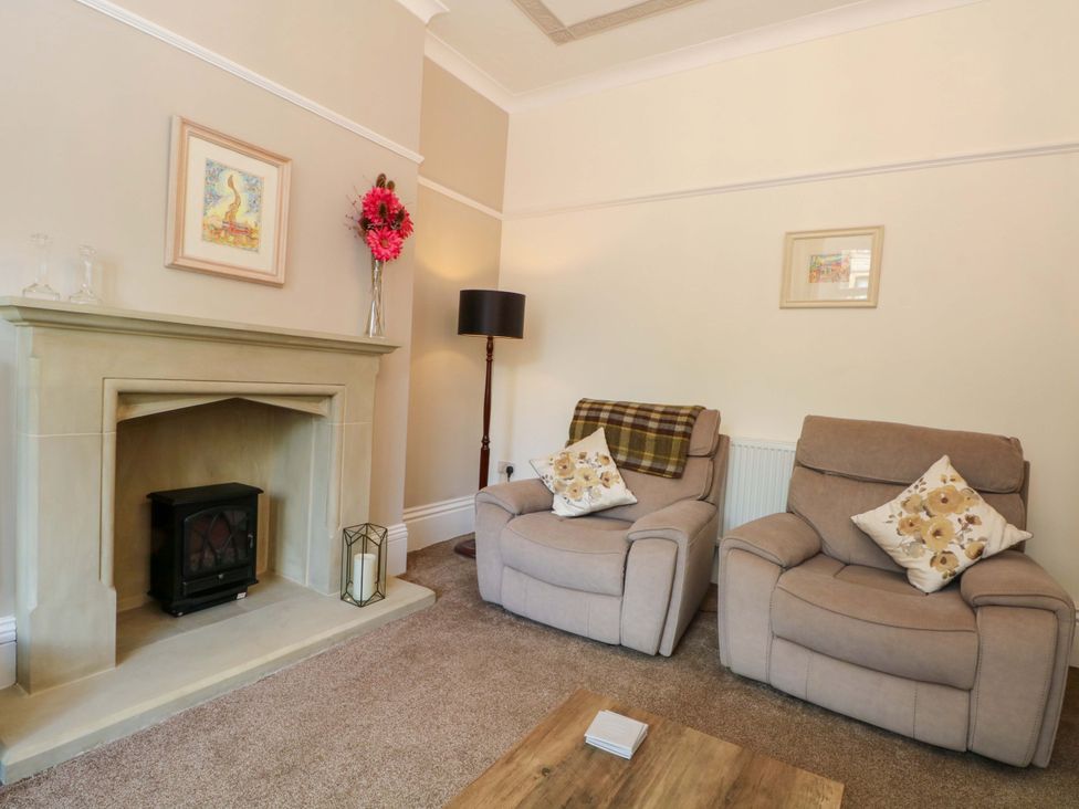 A living room with two armchairs and a fireplace at 163 Manchester Road in Accrington
