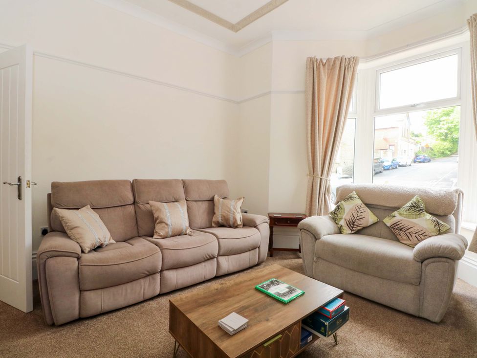 A living room with a sofa and coffee table at 163 Manchester Road Accrington