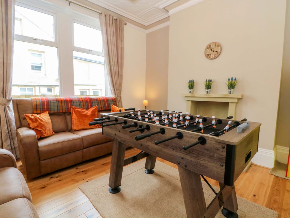 A living room with a foosball table and sofa at 163 Manchester Road in Accrington