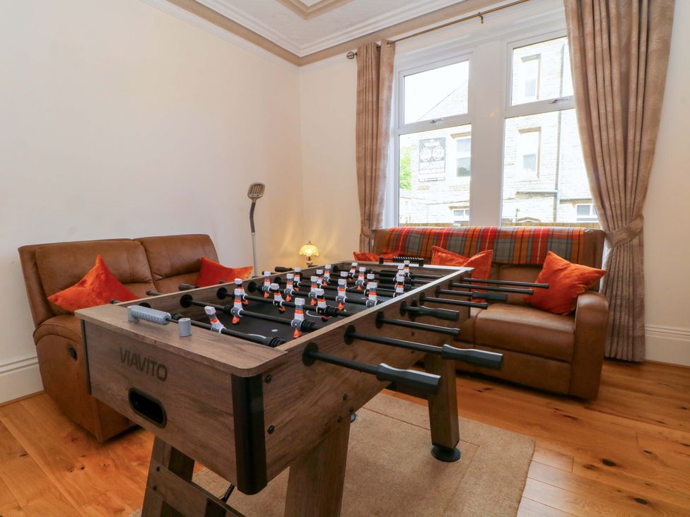 A snug with a foosball table and sofa at 163 Manchester Road Accrington