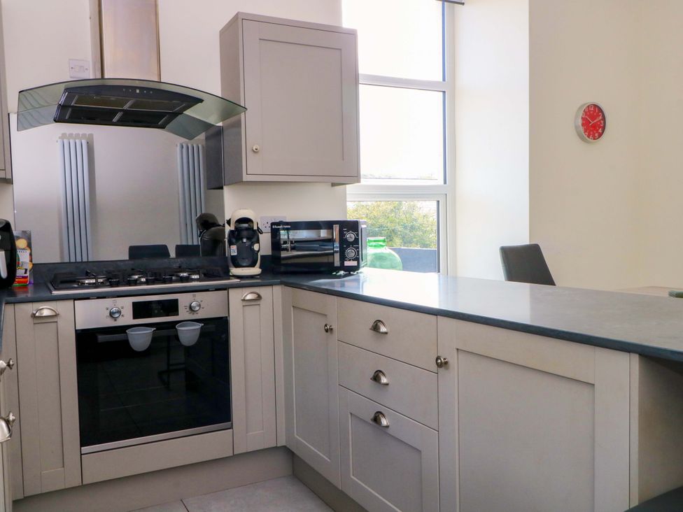 A kitchen with appliances and cabinetry at 163 Manchester Road in Accrington