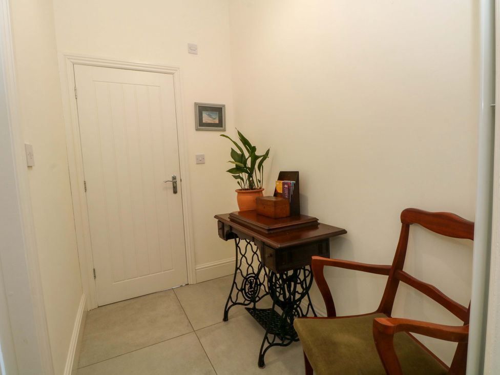 A hallway with a table and chair at 163 Manchester Road in Accrington