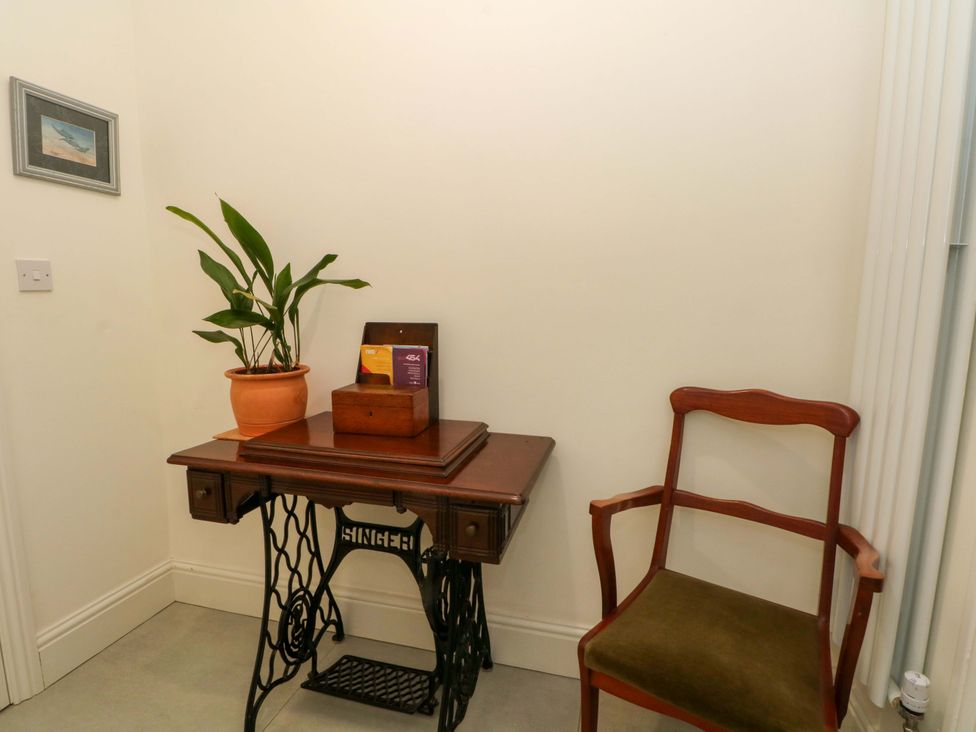 An entryway with a table and chair at 163 Manchester Road in Accrington