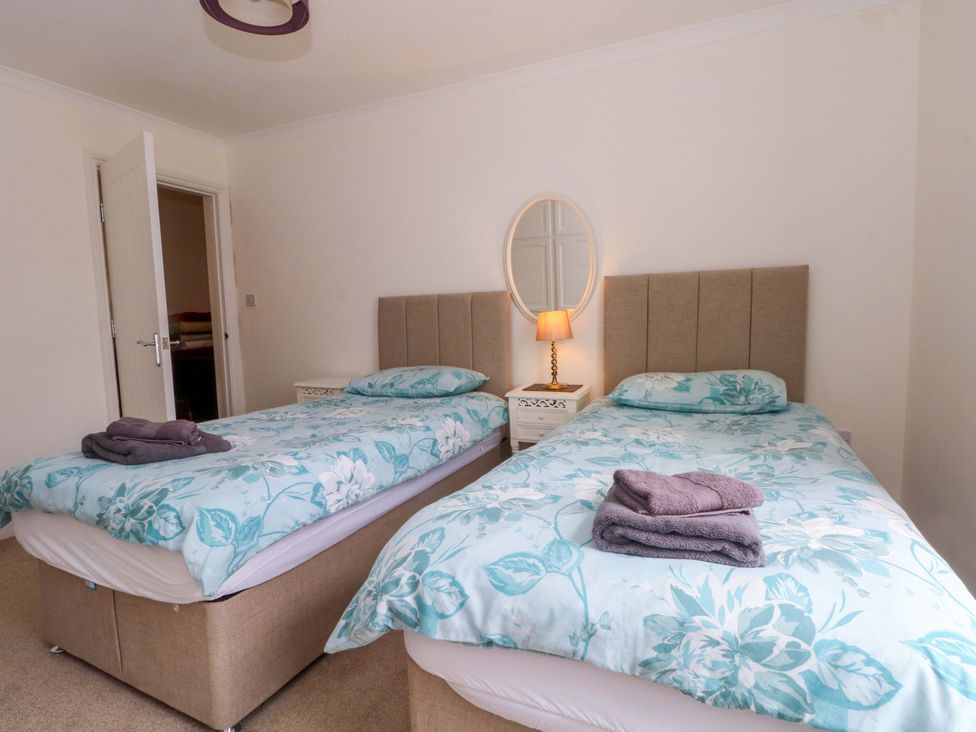 A bedroom with twin beds and a lamp at 163 Manchester Road Accrington