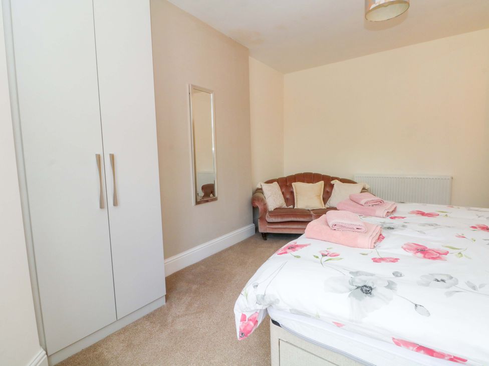 A bedroom with a bed and wardrobe at 163 Manchester Road in Accrington