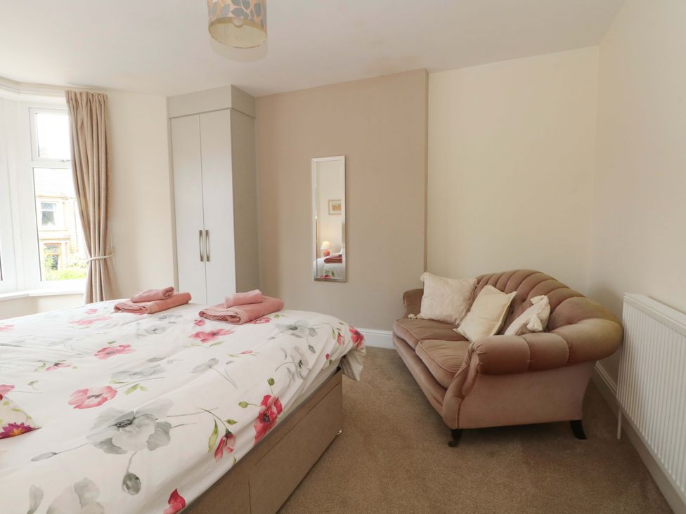A bedroom with a bed and a sofa at 163 Manchester Road in Accrington