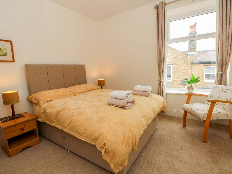 A bedroom with a bed and chair at 163 Manchester Road in Accrington