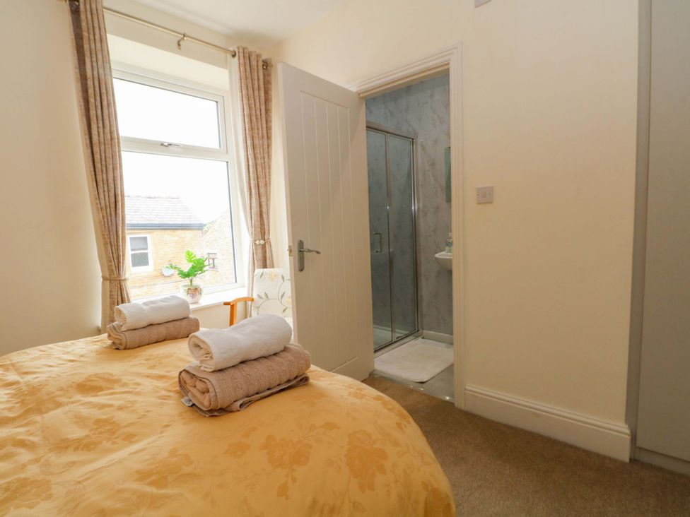 A bedroom with a bed and an adjoining bathroom at 163 Manchester Road in Accrington