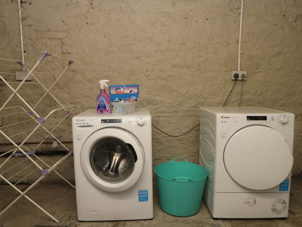 A washing machine and tumble dryer in a laundry room at 163 Manchester Road in Accrington