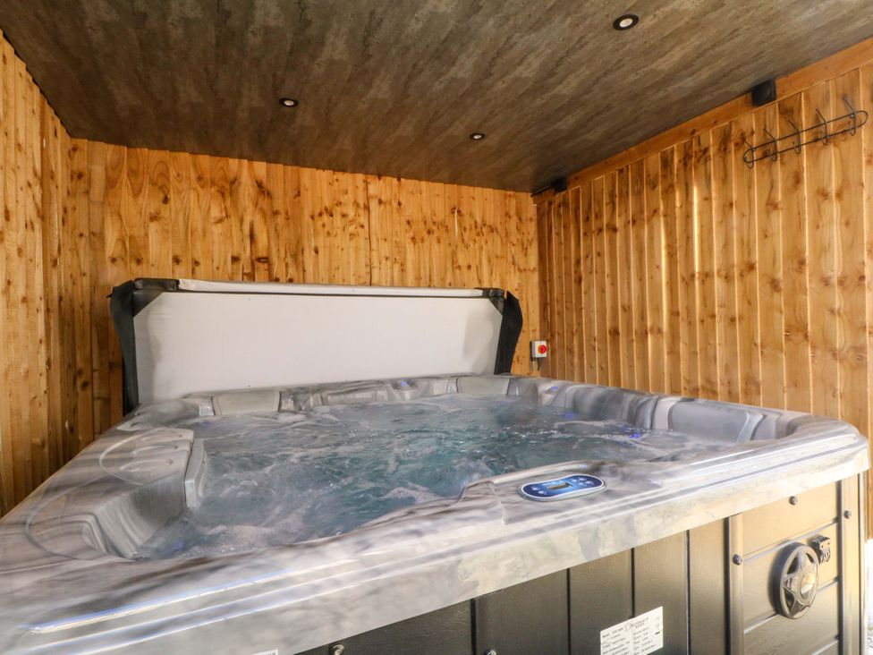 A hot tub with wooden walls and a control panel at 163 Manchester Road Accrington