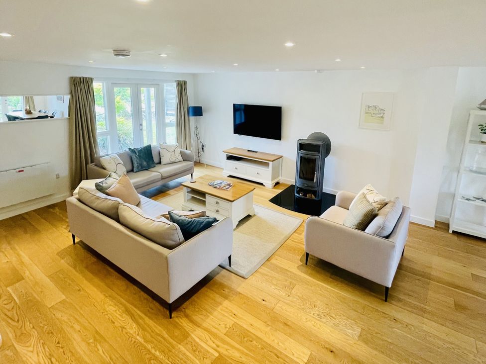 A living room with sofas and a television at Una, Lodge 73, Carbis Bay