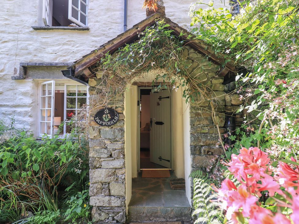 An entryway with a stone structure and a door at Daffodils Ambleside
