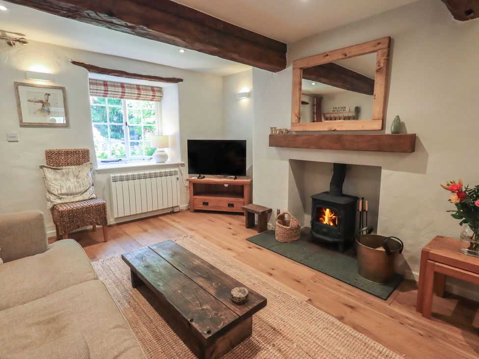 A living room with a sofa and fireplace at Daffodils in Ambleside