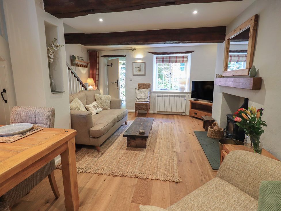 A living room with a coffee table and seating area at Daffodils in Ambleside
