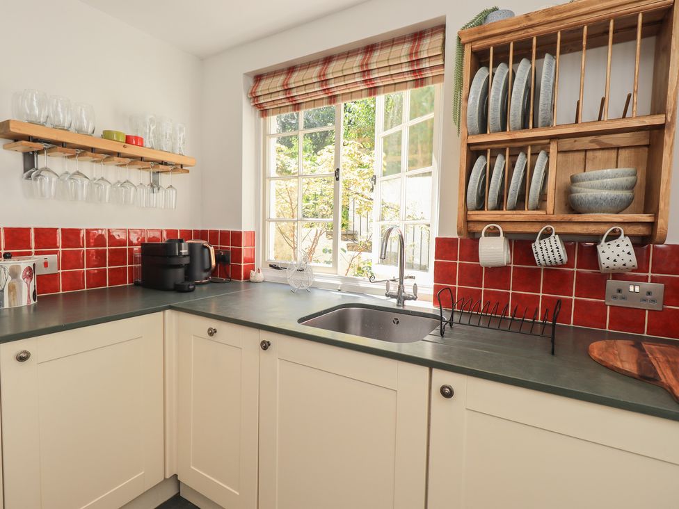 A kitchen with sink and dish rack at Daffodils in Ambleside