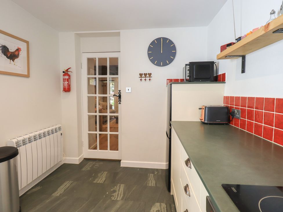 A kitchen with appliances and a door leading outside at Daffodils in Ambleside