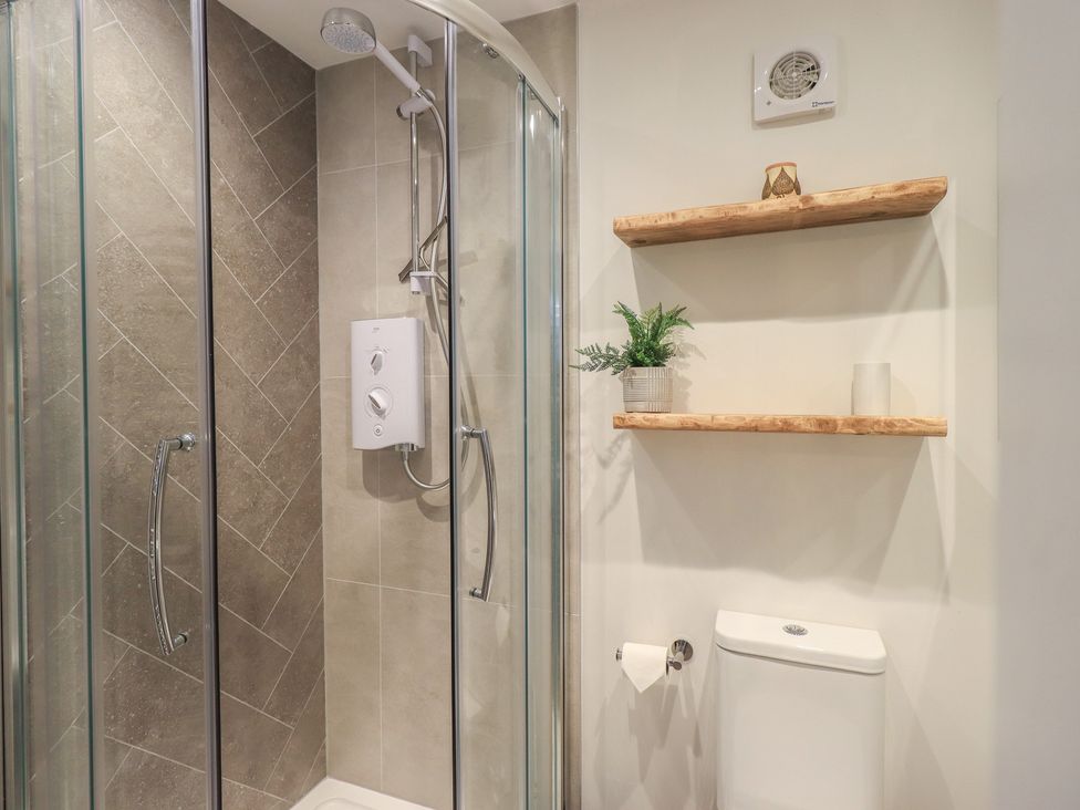 A bathroom with a shower and toilet at Daffodils in Ambleside
