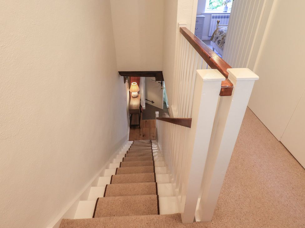 A staircase with a lamp at Daffodils in Ambleside