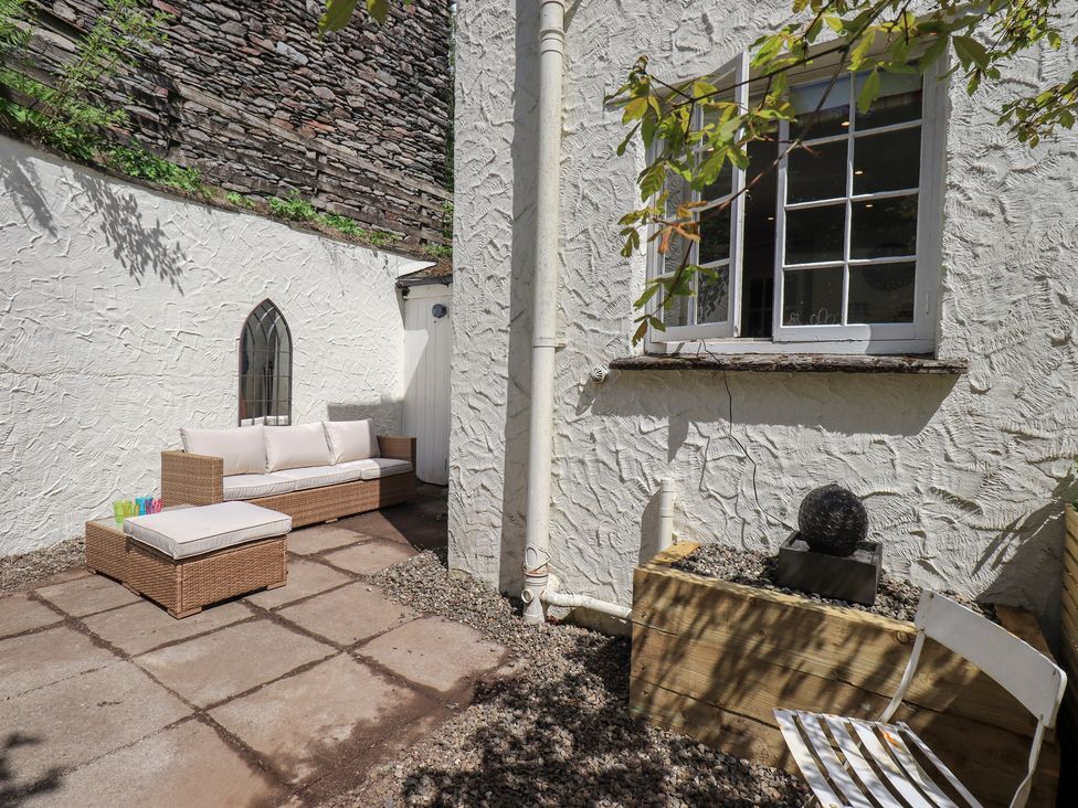 An outdoor seating area with a sofa and planter at Daffodils in Ambleside