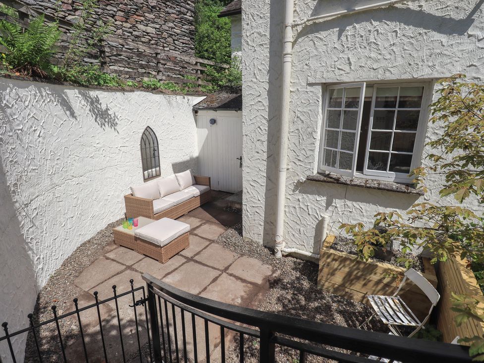 An outdoor seating area with a sofa and table at Daffodils in Ambleside