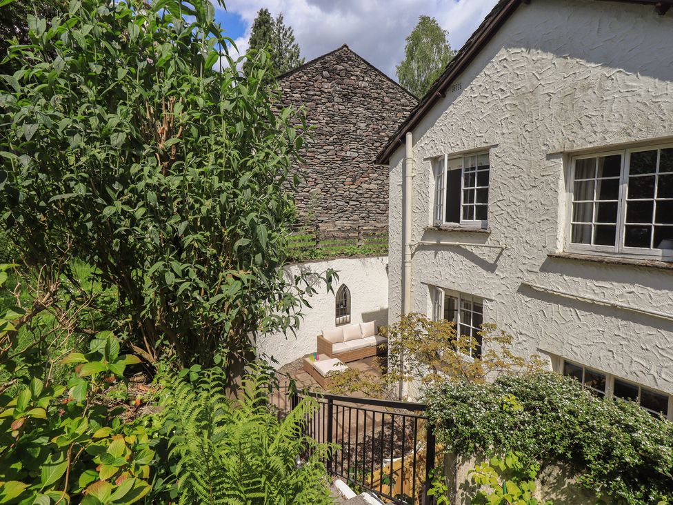 An outdoor area with a sofa next to a house at Daffodils in Ambleside