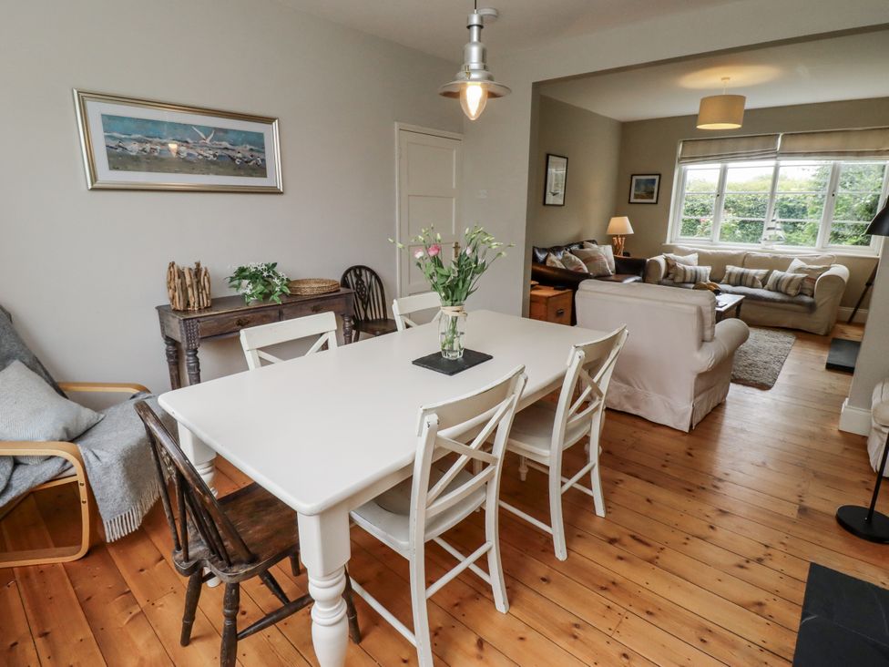 A dining room with a table and chairs at Driftwood in 
