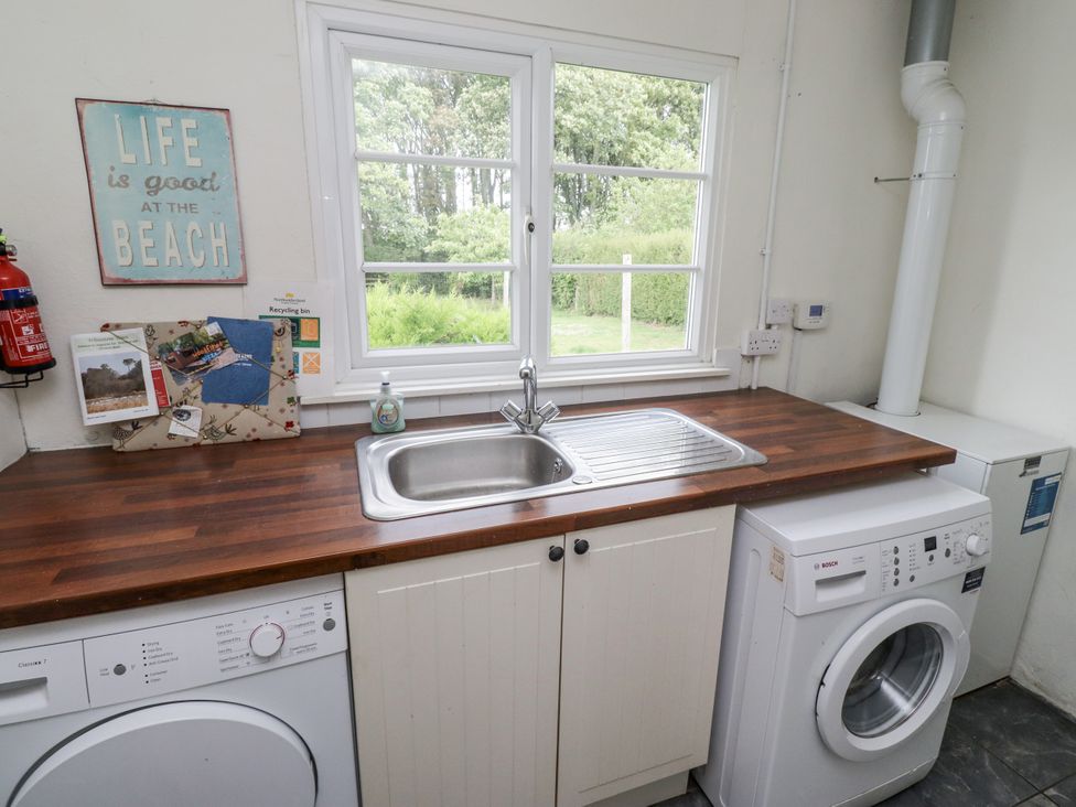 A laundry room with a sink and appliances at Driftwood